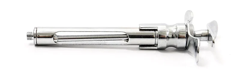 A imagem mostra uma seringa carpule para aplicação de anestésicos, com uma pistola de pressão de material metálico.
