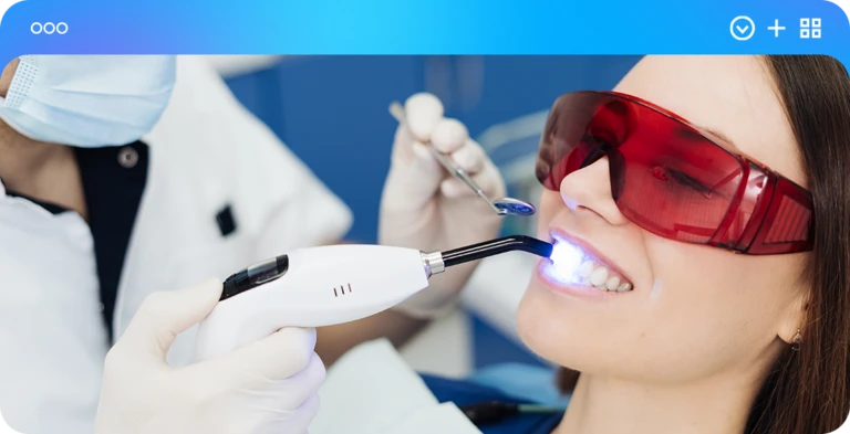 Paciente realiza um procedimento odontológico com uso de tecnologia avançada e óculos de segurança em clínica moderna.